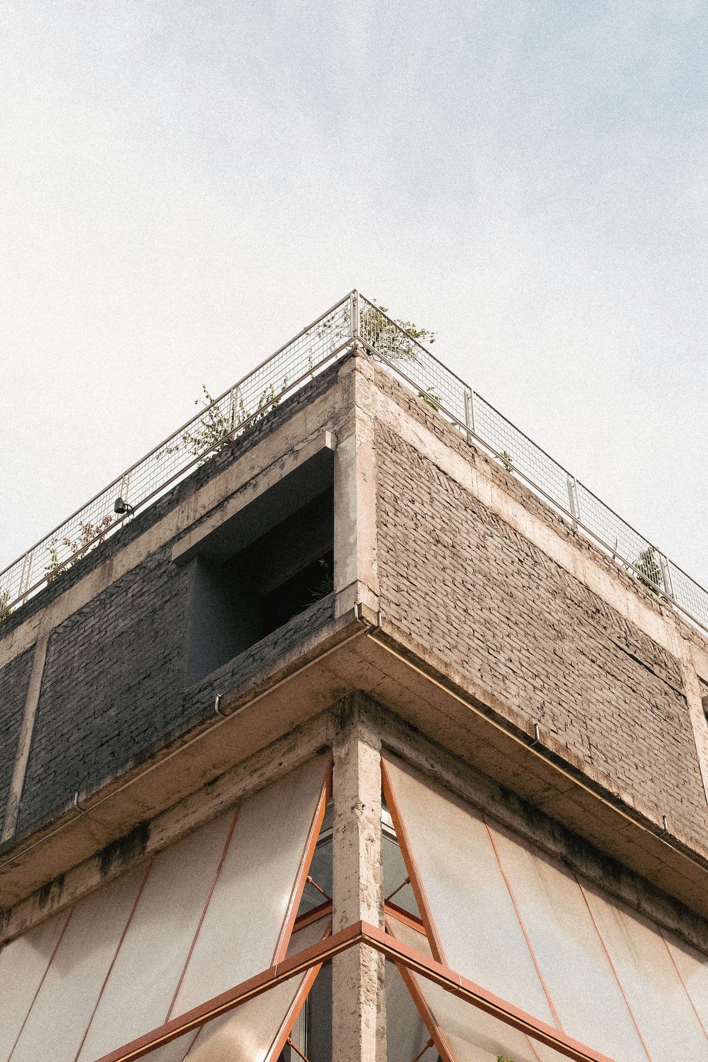 Corner of a brick building against a pale sky