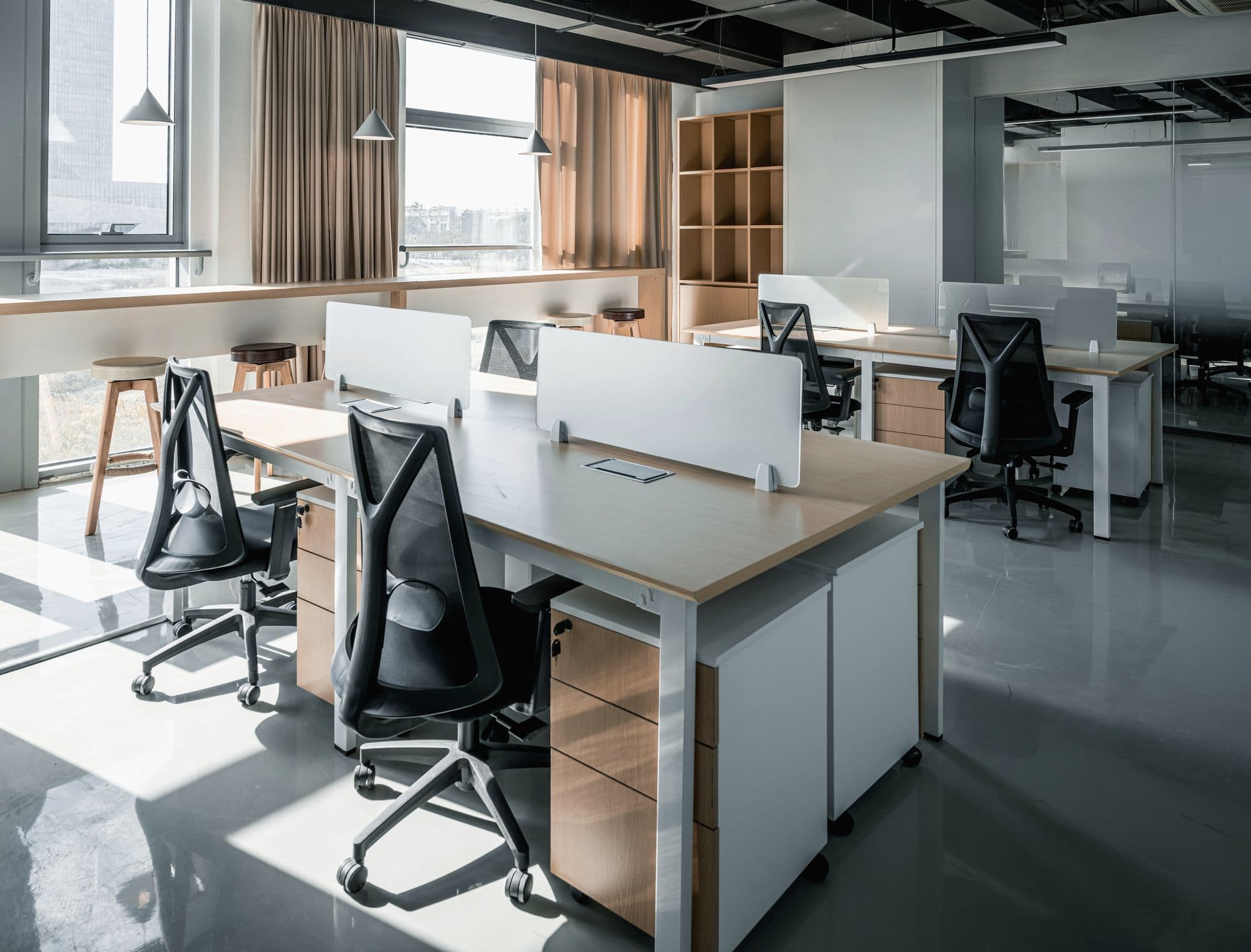 Bright office with desks by the windows